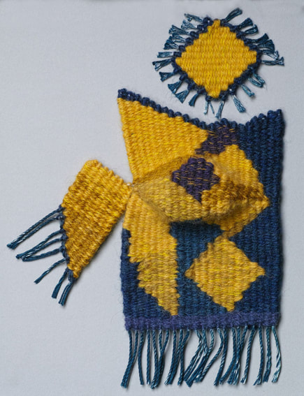Abstract geometric shapes in blue and yellow, with some fringing, on a light coloured background.