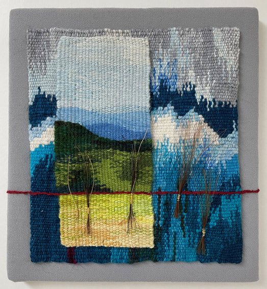 A background made up of blue wave shapes. Overlaid is a separate vertical strip showing a landscape in greens and blues. There is a red strip of thread over both these approximately a third up from the base. There a four small bunches of stiff fibres attached by the red thread.