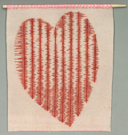 A heart shape made up of red stripes resembling sound waves. The background is cream, suspended from a wooden rod.
